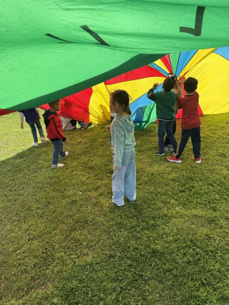 Children of diverse backgrounds playing together outdoors in Katy TX — community and diversity in the Houston suburbs