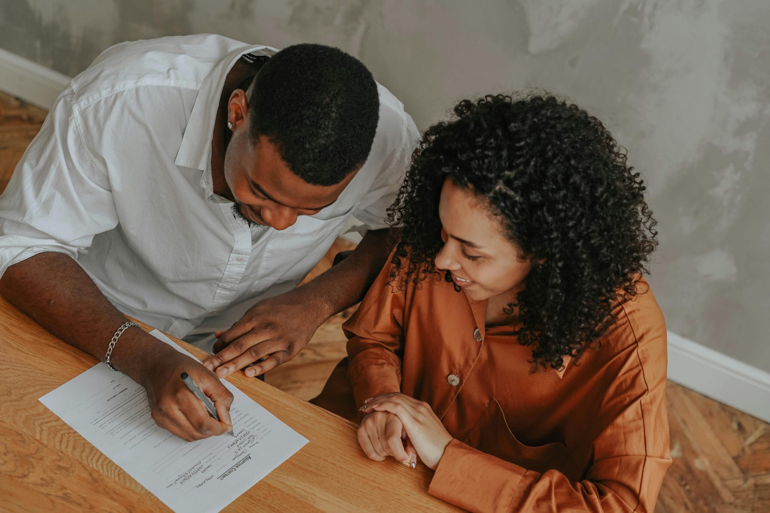 Couple signing documents with a mobile notary in Katy and Richmond TX — Moraea Co. notary services
