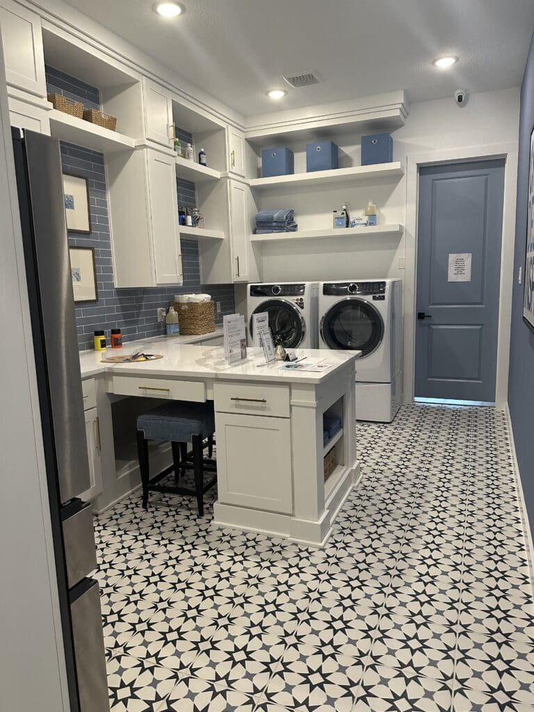 Spacious Houston Texas laundry room with custom cabinetry and built-in desk — what replaces a basement laundry room in Houston homes