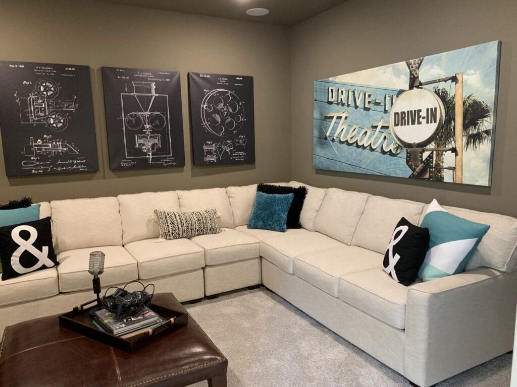 Media room with movie themed decor in a Houston Texas new construction home — basement replacement entertainment space